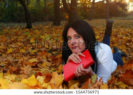 Beautiful brunette woman in the autumn park in the most amazing and colorful period of autumn. Autumn photo shoot. Toned