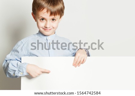 Cute smiling Boy and white empty billboard