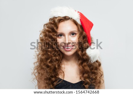 Happy woman in Santa hat smiling on white background. Christmas and New Year party