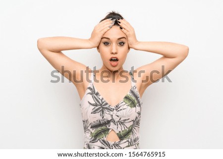 Young woman over isolated white background with surprise facial expression