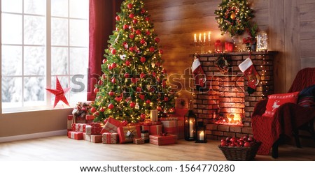 interior christmas. magic glowing tree, fireplace and gifts  
