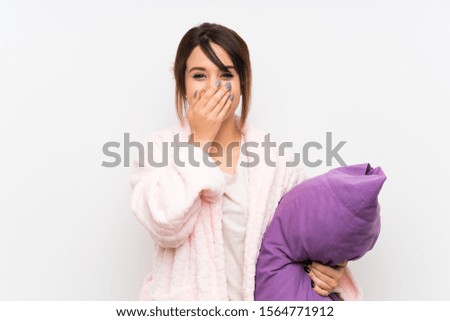 Young woman in pajamas with dressing gown with surprise facial expression