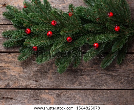 Christmas background with branch of tree on wooden table
