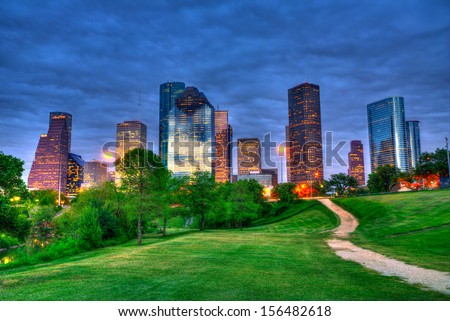 Houston Texas modern skyline at sunset twilight from park lawn