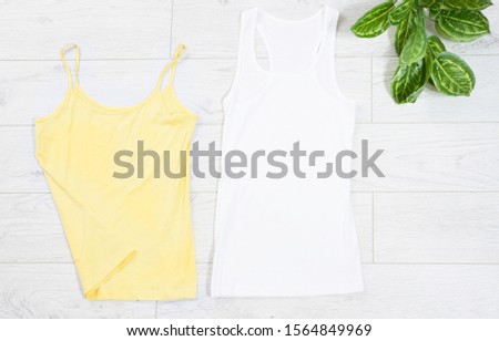 Clothes background top view, accessories summer concept t-shirt mock up on wooden floor, fashion shirt empty for logo, empty tshirt mockup background