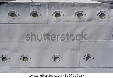 Side of distroyer ORP Blyskawica (Lightning),  with rows of portholes as background with copy space. Blyskawica served during World War II and is the oldest preserved destroyer in the world