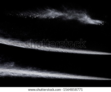 trail from a jet engine on a black background, spraying particles under high pressure Royalty-Free Stock Photo #1564858771