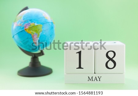 Spring calendar for May 18 on a green background, the concept of heat and holidays