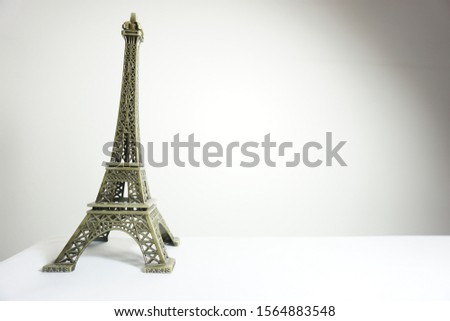 Eiffel tower standing in front of a white backdrop
