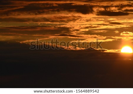 beautiful sunset on the background of clouds over the river