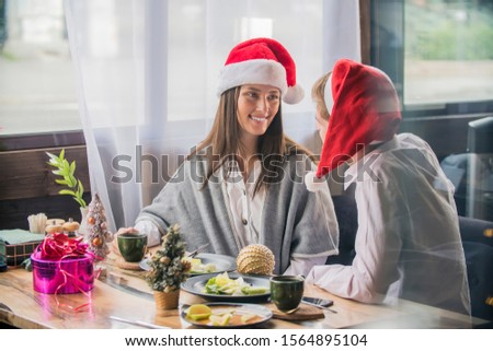 Man and woman, santa claus hats cheerful celebrating new year. Merry christmas. Celebrating together winter holiday