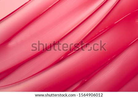 Lip gloss pink red smear background texture Royalty-Free Stock Photo #1564906012