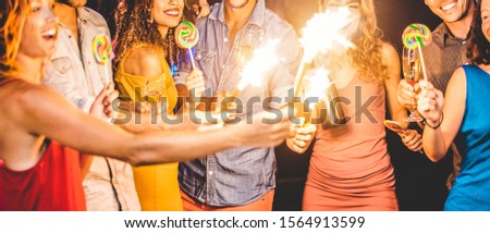Happy friends celebrating new year's eve inside disco club dancing and drinking champagne - Young people having fun at night party - Holidays concept - Focus on girl mouth with yellow dres