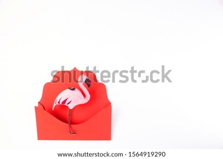 Flamingo bird in red envelope isolated on white background