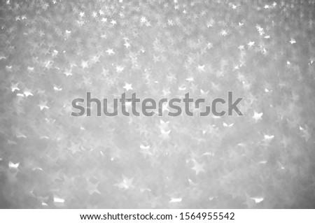 Festive Silver Background with Star Shaped Bokeh Effect