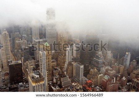 Top view of New York skyline in rainy and cloudy day. Skyscrapers of NYC in the fog. Stunning and magnificent view of famous city