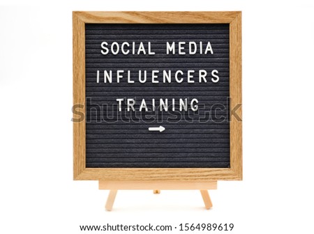 Social media influencers training welcome board at meeting conference course desk. Sign made with a letters board with an arrow indicating direction white characters on grey background. 