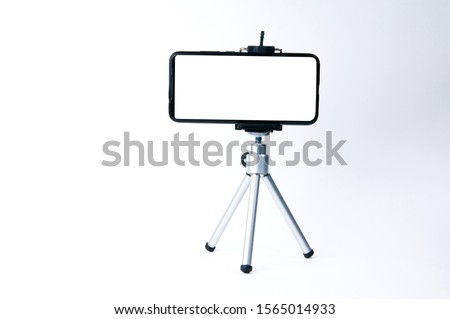 Smartphone mounted on a tripod as a monitor for viewing on a white background