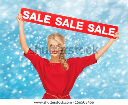 shopping, gifts, christmas, x-mas concept - smiling woman in red dress with sale sign