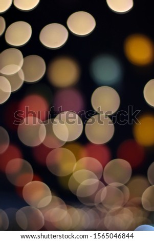 Blurred background with colorful bokeh from lighting at night on black background.