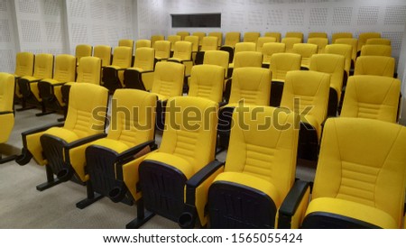 rows of yellow chairs that are still empty
