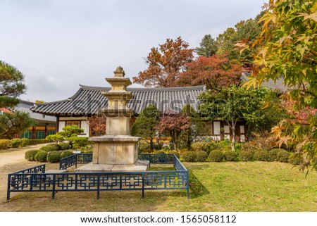 A landscape view of a mountain temple covered with maple trees.
