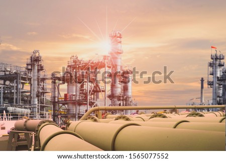 close up green pipe line, Tubes running pipe line transportation is most mammon way of transporting goods such as oil, natural gas or water on long distance on sunset background. Royalty-Free Stock Photo #1565077552