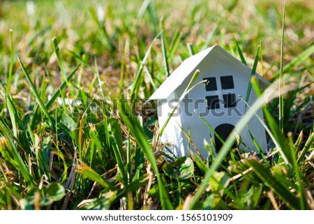 House on green grass. Real estate sale.Concept: buying, selling and renting real estate.