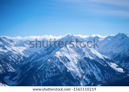 Photo of picturesque highlands with snow mountains and blue sky