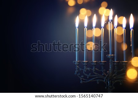 Religion image of jewish holiday Hanukkah background with menorah (traditional candelabra) and candles Royalty-Free Stock Photo #1565140747