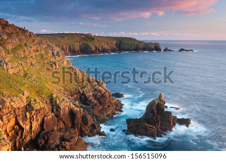 Rock formation knowns as the Irish Lady at Sennen Cove with Lands End in the distance Cornwall England UK