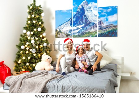 family laughing in bed at christmas