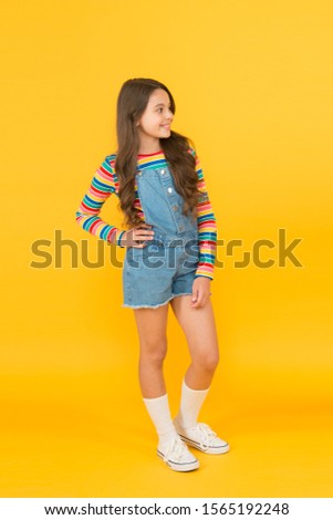 summer kid fashion. Child happy mood. Girl smiling face. Universal childrens day. childhood happiness. cheerful hipster girl colorful clothes. optimist concept. small girl yellow background.