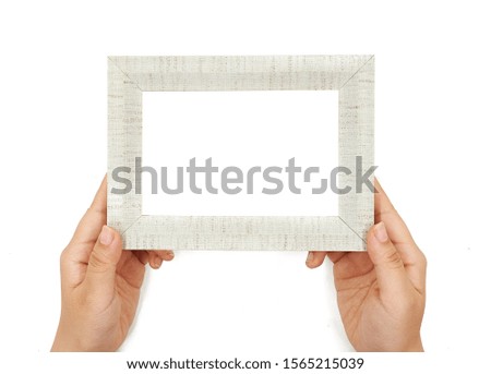 Female hand holding Photo frame on white background                               