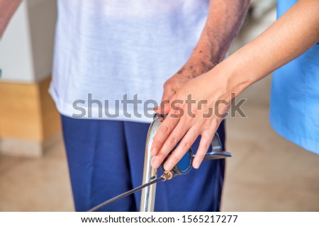 Elderly people helped by nurse in the hospital, close-up