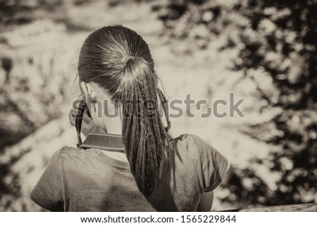 Back view of young girl photographing National Park. Education and holiday concept.