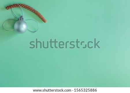 Christmas silver ball on a branch on a green background flat new year minimalism background