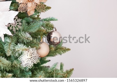 Beautiful decorated Christmas tree on light background, closeup