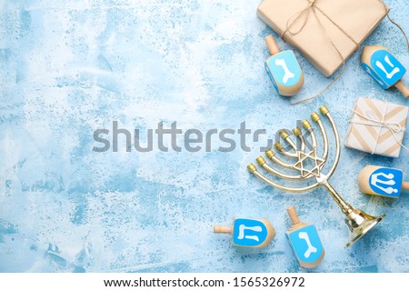 Beautiful composition for Hannukah on color background Royalty-Free Stock Photo #1565326972