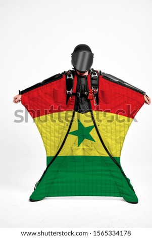 Senegal flag travel. Bird Men in wing suit flag. Sky diving men in parashute. Patriotism, men and flag.
                              