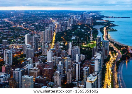 Business concept for real estate and corporate construction - panoramic urban city skyline and ocean aerial view under bright sky and beautiful sunset in Chicago, America