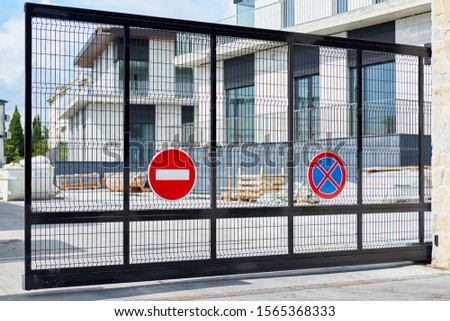 Stop signs on the gate of the closed private area. Warning, closed territory.