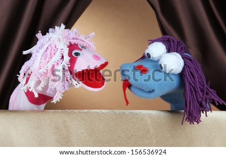 Puppet show on brown background Royalty-Free Stock Photo #156536924