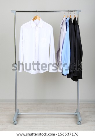 Office  male clothes on hangers, on gray background Royalty-Free Stock Photo #156537176