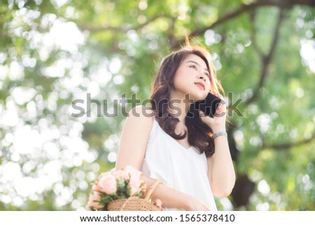 Asian women talking cellphone in city public park business connection concept