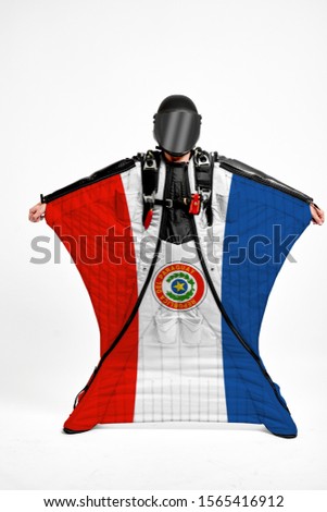 Paraguay flag travel. Bird Men in wing suit flag. Sky diving men in parachute. Patriotism, men and flag.
                              
