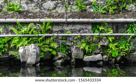 Mirror water stone walls with pipes