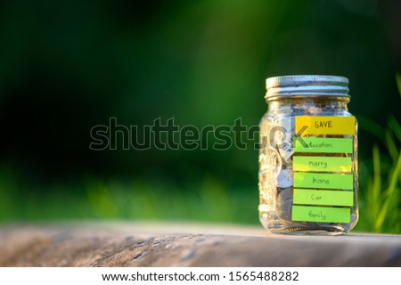 Write a savings message for the future. Stick the jars with money inside.