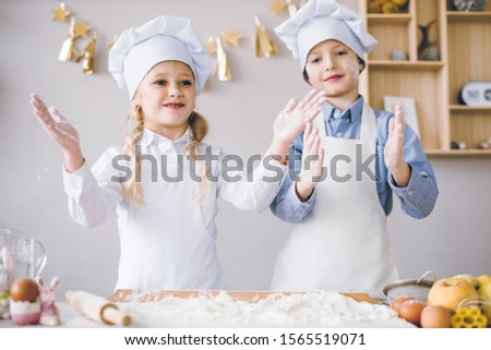 Funny little bakers. The children baked Christmas cakes.
