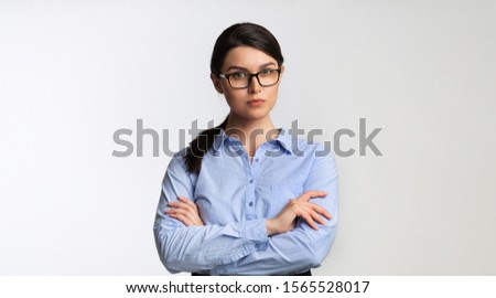 Business People. Serious Businesswoman Looking At Camera Crossing Hands Standing Over White Studio Background. Panorama, Copy Space